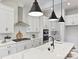 Modern kitchen with white cabinets, quartz countertops and a gas cooktop at 3837 Bon Rea Dr, Charlotte, NC 28226