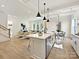 Bright kitchen boasts an island, stainless steel appliances, and hardwood floors at 3837 Bon Rea Dr, Charlotte, NC 28226