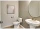 Simple powder room with a pedestal sink and circular mirror at 4003 Bourne Ct, Charlotte, NC 28262