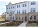 Two-story townhome with gray siding and brick at 4007 Bourne Ct, Charlotte, NC 28262