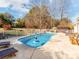 Inviting swimming pool with patio furniture and a tranquil backyard setting at 4509 Long Cove Dr, Denver, NC 28037