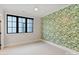 Bedroom with leafy wallpaper and a large window at 504 Mcalway Rd, Charlotte, NC 28211