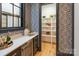 Stylish butler's pantry with white shelving, geometric wallpaper, and quartz countertops at 504 Mcalway Rd, Charlotte, NC 28211