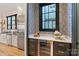 Kitchen wet bar with beverage cooler and geometric wallpaper at 504 Mcalway Rd, Charlotte, NC 28211