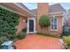 Inviting entryway with brick facade and landscaping at 7507 Hurstbourne Green Dr, Charlotte, NC 28277