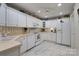 White kitchen with ample cabinetry and a tiled floor at 7507 Hurstbourne Green Dr, Charlotte, NC 28277