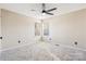 Bedroom with two windows, ceiling fan, and neutral walls at 8325 Springhead Ln # 48, Charlotte, NC 28215