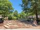 Landscaped community greenspace with stone steps and benches at 13844 Hill St, Huntersville, NC 28078