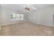 Large living room with carpet, ceiling fan, and lots of natural light at 15019 Ockeechobee Ct, Mint Hill, NC 28227