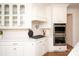 Modern kitchen with double oven, gas cooktop and white shaker cabinets at 1606 Alydar Ct, Waxhaw, NC 28173