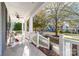 Spacious front porch with white railings, ceiling fan, and street view at 19818 Wooden Tee Dr, Davidson, NC 28036