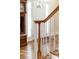 Elegant staircase with wood railings and white spindles at 19818 Wooden Tee Dr, Davidson, NC 28036