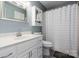 Clean bathroom with white vanity, shower, and updated flooring at 204 W 18Th St, Newton, NC 28658