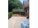 Concrete patio, partially shaded, with a blue chair and landscaping at 204 W 18Th St, Newton, NC 28658