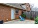 Small patio with brick wall and blue Adirondack chair at 204 W 18Th St, Newton, NC 28658