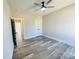 Bedroom with hardwood floors, double doors to closet, and access to hallway at 209 Prospect Church Rd, Albemarle, NC 28001