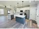 Modern kitchen with white cabinets, large island, and stainless steel appliances at 209 Prospect Church Rd, Albemarle, NC 28001