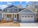 Two-story house with gray siding, white garage door, and a brick porch at 2406 Forrestbrook Dr, Kannapolis, NC 28083