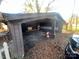 A carport attached to the house, with some debris on the ground at 3217 Howe Dairy Rd, Gastonia, NC 28056