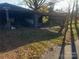 Carport with a covered area and a small bench, surrounded by leaf-covered ground at 3217 Howe Dairy Rd, Gastonia, NC 28056
