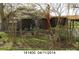 Brown house with white accents, surrounded by trees and landscaping with small white fence at 3217 Howe Dairy Rd, Gastonia, NC 28056