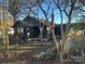 Dark-colored house with a chimney, surrounded by trees and a yard at 3217 Howe Dairy Rd, Gastonia, NC 28056