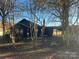 Dark-colored house with a chimney, surrounded by trees and a yard at 3217 Howe Dairy Rd, Gastonia, NC 28056