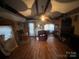 Living room with hardwood floors, exposed beams, and a view into the kitchen at 3217 Howe Dairy Rd, Gastonia, NC 28056