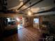 Living room with hardwood floors, exposed beams, and stone accent wall at 3217 Howe Dairy Rd, Gastonia, NC 28056