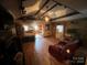 Spacious living room features exposed beams, stone wall, and hardwood floors at 3217 Howe Dairy Rd, Gastonia, NC 28056