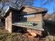 Wooden shed with ladder on roof and wheelbarrow at 3217 Howe Dairy Rd, Gastonia, NC 28056