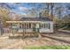 Charming white cottage with a covered porch and landscaped yard at 412 N Vance St, Gastonia, NC 28052