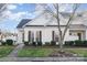 Charming townhome with white and brown exterior, landscaping, and a welcoming walkway at 6203 Tyrel Ln, Harrisburg, NC 28075