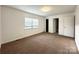 Bright bedroom with neutral carpeting and ample closet space at 6719 Paloverde Ln, Charlotte, NC 28227