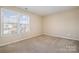 Well-lit bedroom featuring neutral walls and carpet at 8140 Haviland Ln, Fort Mill, SC 29707