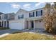 Two-story house with beige siding, dark blue door, and attached garage at 8140 Haviland Ln, Fort Mill, SC 29707