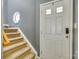 Staircase with neutral carpeting and a white door at 8140 Haviland Ln, Fort Mill, SC 29707