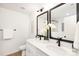 Modern bathroom with double vanity, black framed mirrors, and white cabinets at 9716 Lawing School Rd, Charlotte, NC 28214