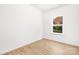 Simple bedroom with light walls, wood flooring and a window at 9716 Lawing School Rd, Charlotte, NC 28214