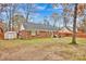 Backyard view of home with storage shed and patio area at 2005 Wilson Ave, Monroe, NC 28110