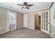 Bedroom with ceiling fan, neutral walls, and French doors at 3040 Wagonwheel Ct, Belmont, NC 28012