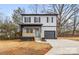 Two-story house with gray siding, black accents, and a light blue front door at 310 Town St, Landis, NC 28088