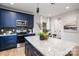 Modern kitchen with blue cabinetry, stainless steel appliances, and granite countertops at 310 Town St, Landis, NC 28088