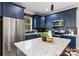 Modern kitchen with blue cabinetry, stainless steel appliances, and granite countertops at 310 Town St, Landis, NC 28088