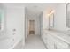 Elegant bathroom with double vanity, soaking tub, and marble flooring at 3110 Westerwood Dr, Charlotte, NC 28214