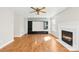 Living room with hardwood floors, fireplace, and built-in shelving at 4407 Wills Way, Charlotte, NC 28227