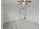 Bright bedroom with grey carpet, ceiling fan, and double-door closet at 618 Lake Dr, Rockwell, NC 28138