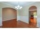 Bright dining room with hardwood floors and elegant chandelier at 7120 Kinley Commons Ln, Charlotte, NC 28278