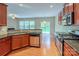 Open kitchen with island, granite counters, and view to backyard at 7120 Kinley Commons Ln, Charlotte, NC 28278