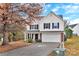 Two-story house with beige vinyl siding, brick accents, and a two-car garage at 808 Plateau Ct, Rock Hill, SC 29730